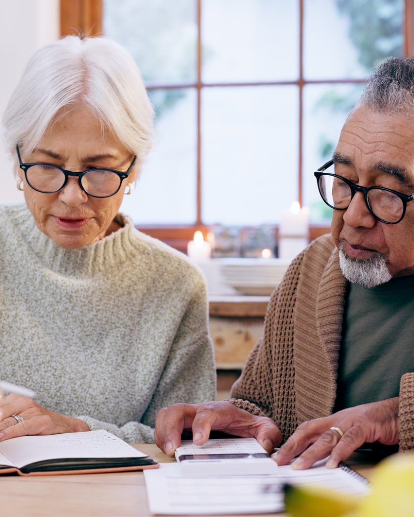 senior-couple-paperwork-and-contract-with-signature-and-life-insurance-information-for-will-and-po senior-couple-paperwork-and-contract-with-signature-and-life-insurance-information-for-will-and-po