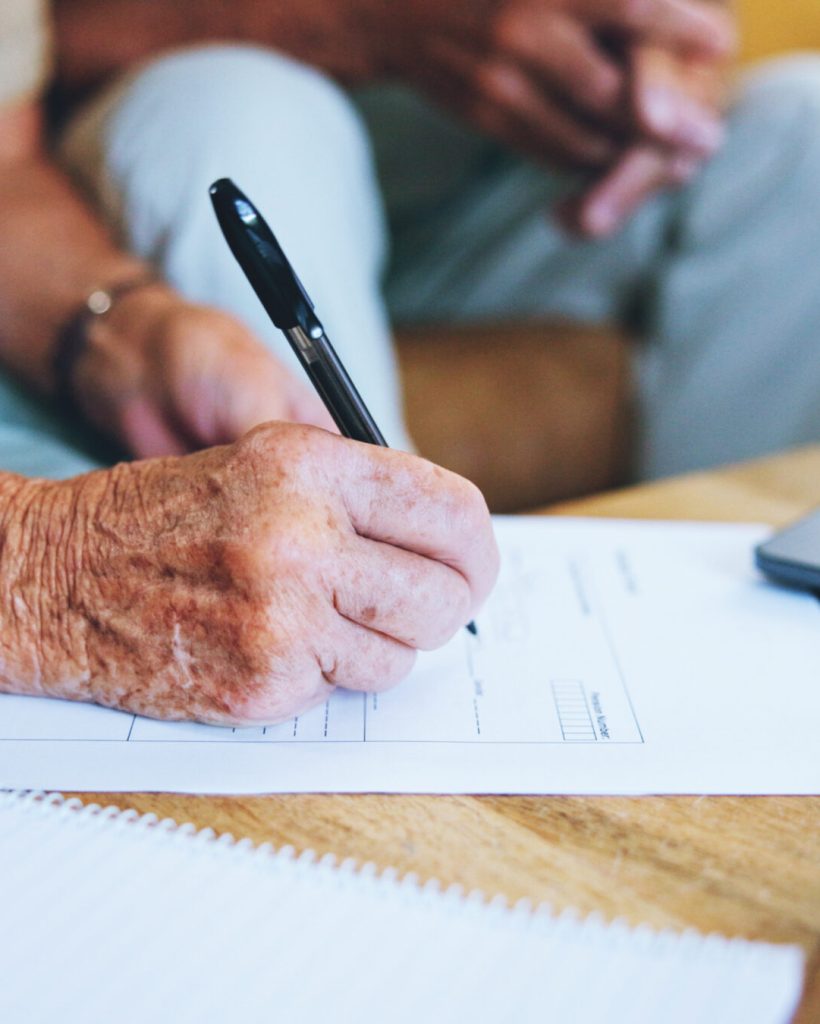 senior-man-paperwork-and-hands-to-sign-or-home-fo-2025-04-06-11-06-42-utc Senior man, paperwork and hands to sign or home for finance, life insurance and planning for assets.